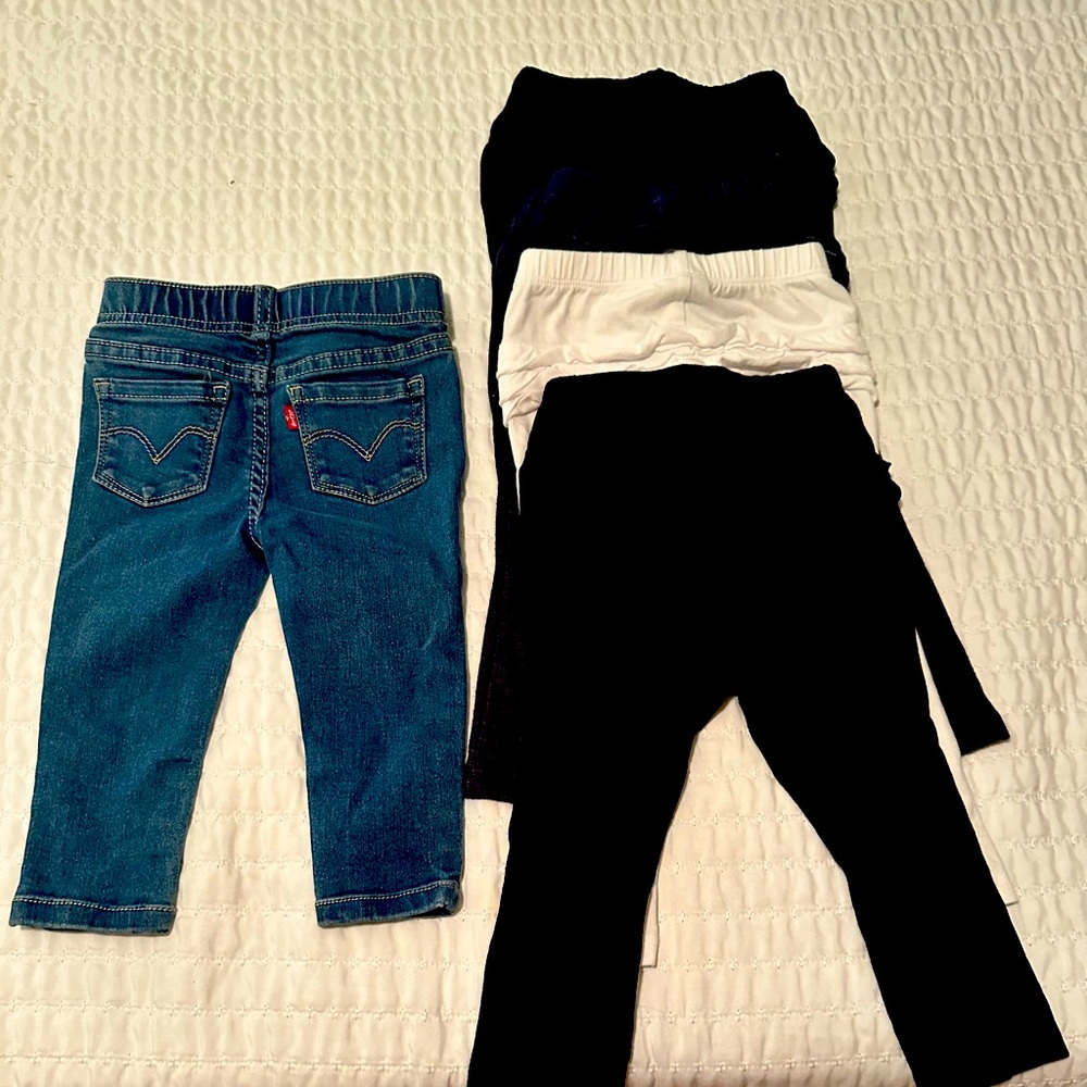 4 pair of ruffled leggings and 1 pair of Levi’s